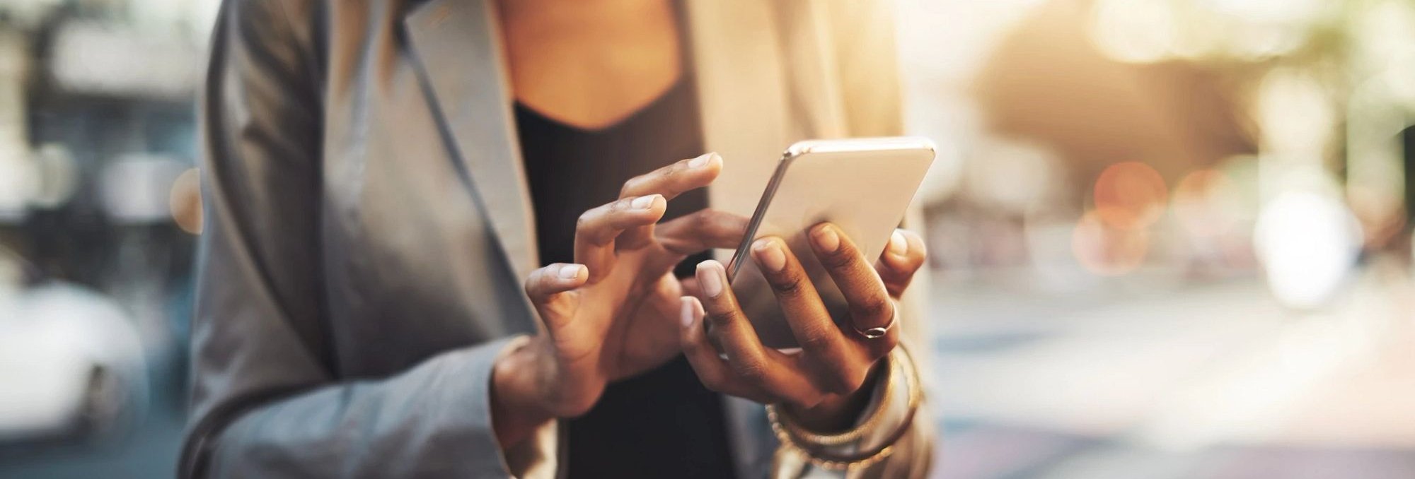 Person using smartphone to contact The Furniture Store in the Brighton, MI area