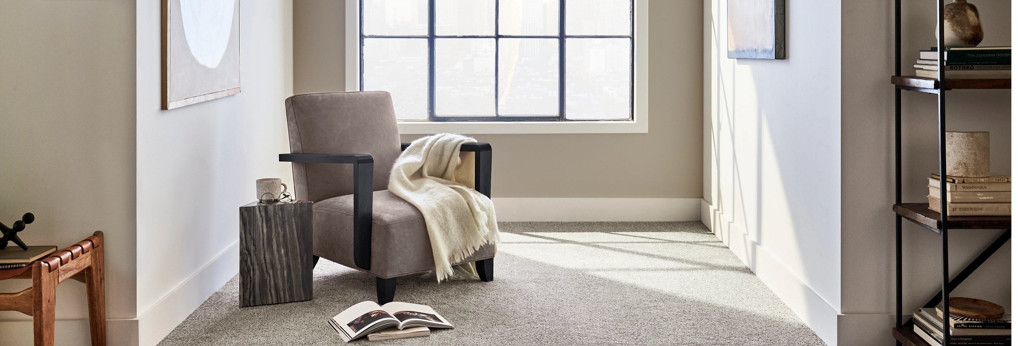 Armchair near the window in a room with grey carpet from The Furniture Store in the Brighton, MI area