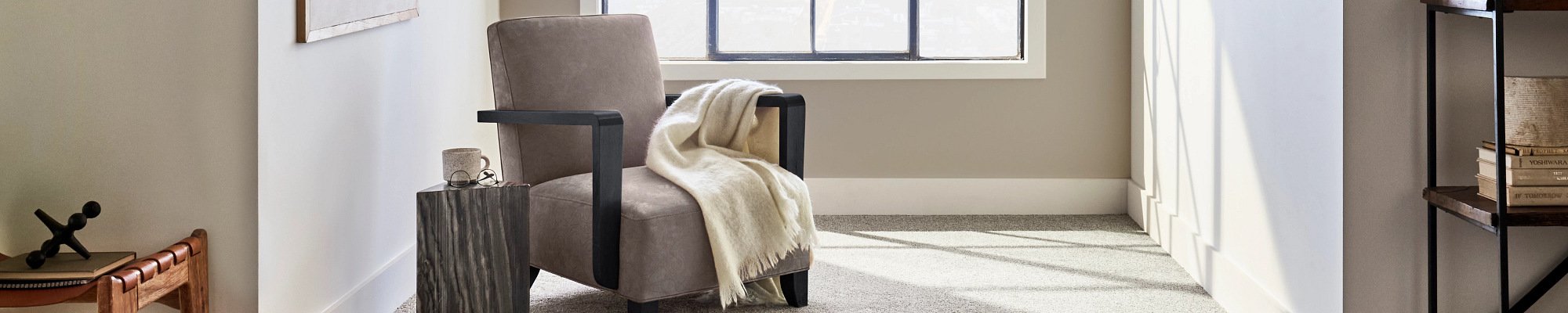 Armchair near the window in a room with grey carpet from The Furniture Store in the Brighton, MI area